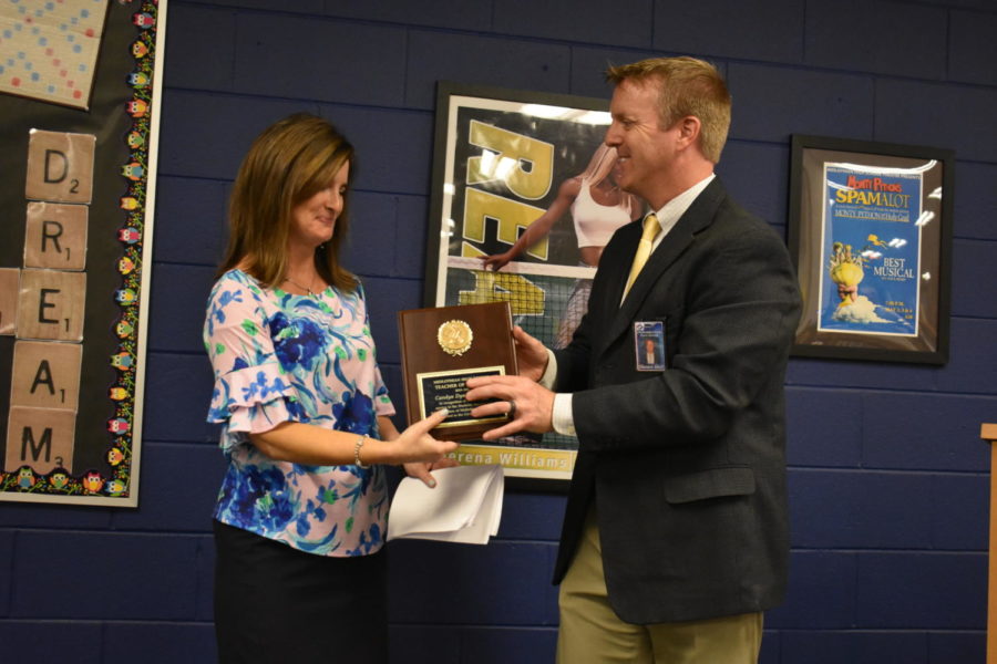 Principal Shawn Abel awards Mrs. Carolyn Manheim the Teacher of the Year award.