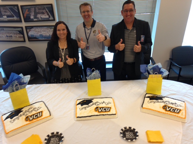 Dr. Bowes, Dr. Abel, and Dr. Gifford pose in front of their special cakes the staff bought to celebrate their graduation.