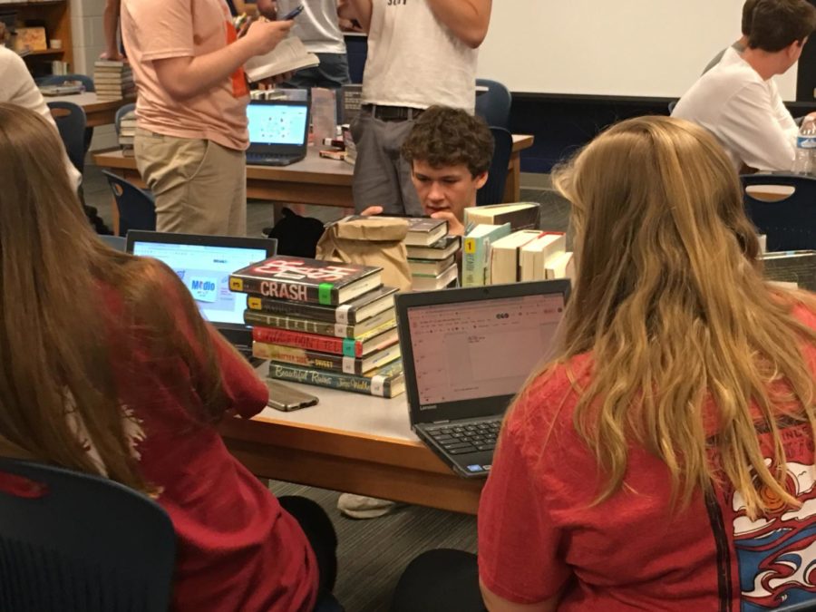 Senior Joe Hester creates Book Spine Poetry in Mrs. Tullys AP Lit class.