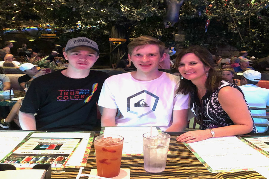 Ben Wrobel, Jakob Marshall, and Mrs. Carolyn Manheim dine at the Rainforest Cafe in Orlando.