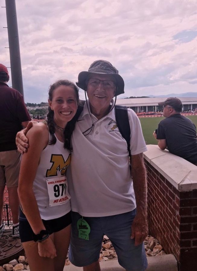 Sophomore Millie Weinhold and Coach Stan Morgan hug after the 2019 State Track and Field Meet.
