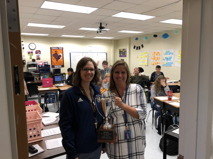 Mrs. Rachel Hill awards the TRT trophy to English teacher, Mrs. Blair Abrahamson.