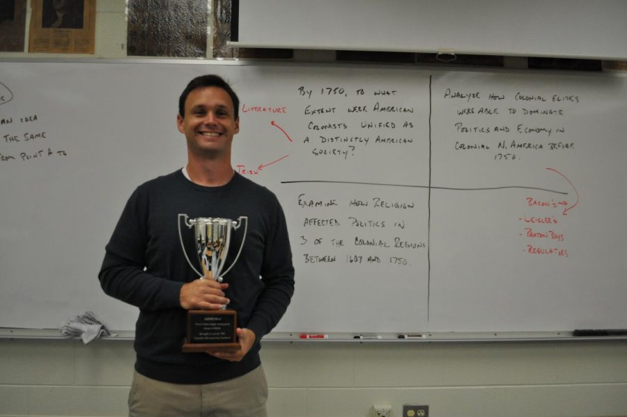 Mr. Fout holds the TRT trophy awarded by Mrs. Abrahamson.