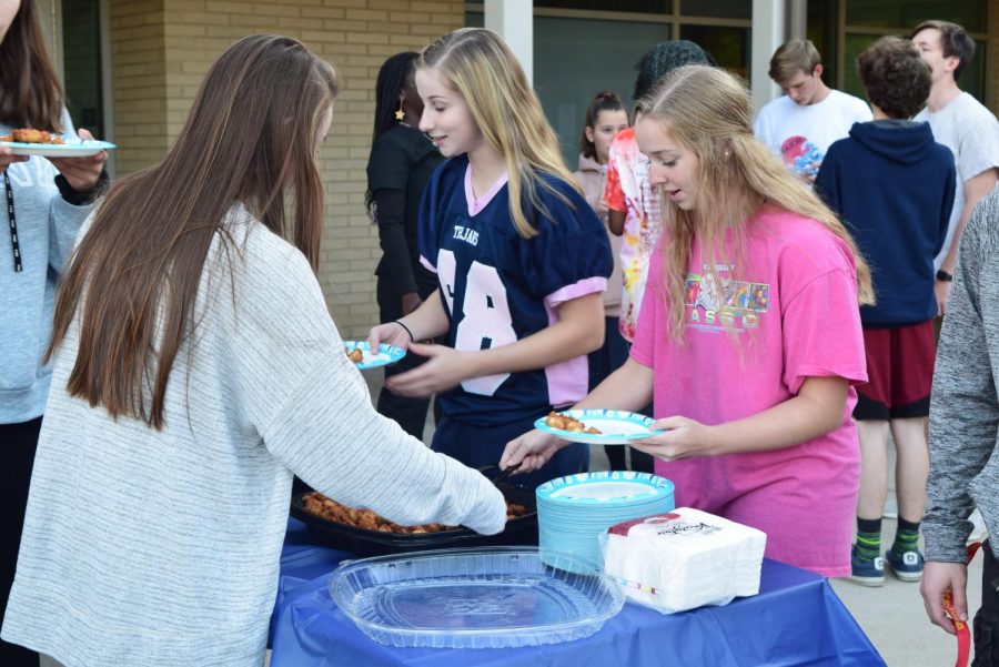 Senior Class Secretary and Treasurer Rachel Damico and Sarah Aud along with Council member Elizabeth Potts enjoy Chick-fil-a provided by the Senior Class officers at the 2019 Tailgate.