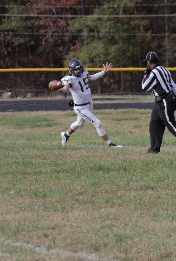 Junior Braden Berger runs down the field for the attempt of a Trojans touchdown.
