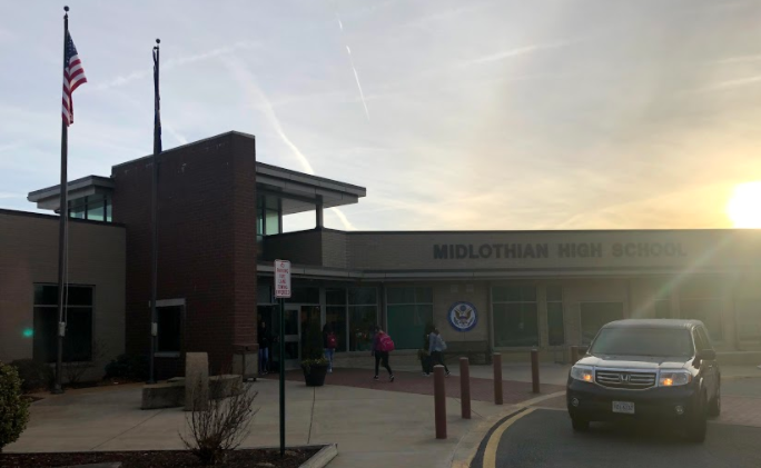 Students enter through the doors of Midlothian High School.