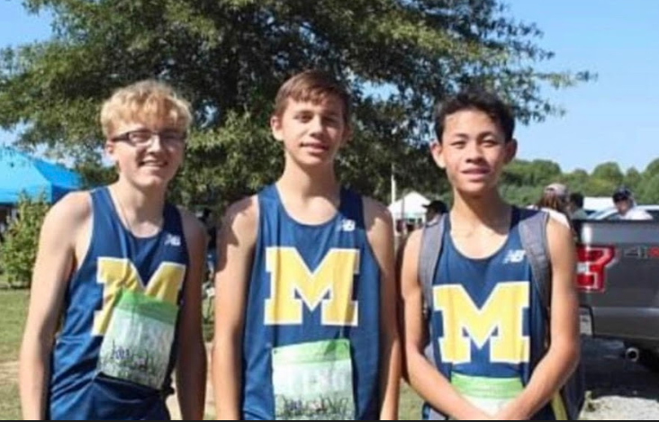 Freshman Josh Huddle, Nathan Petroski, and Kevin Huang celebrate after a cross country race.