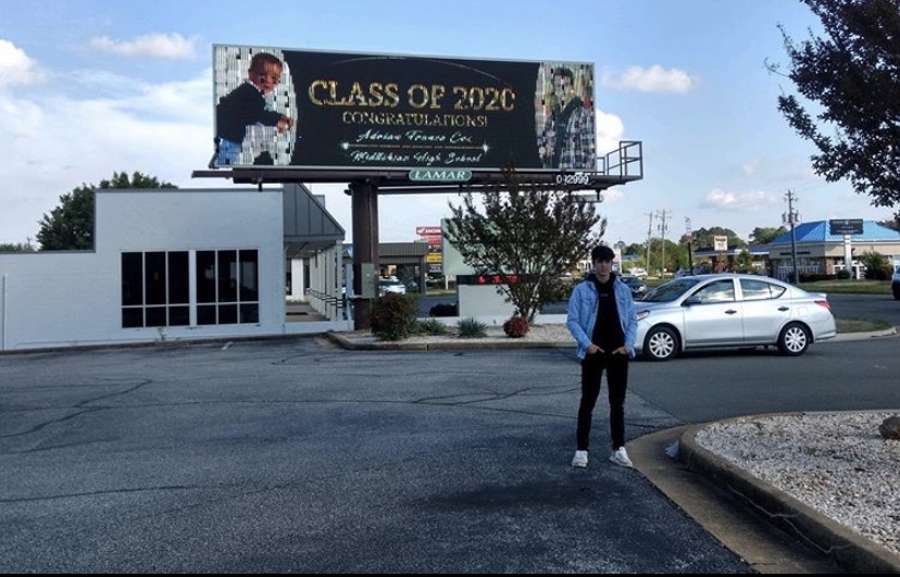 Adrian Cox celebrates his senior year while admiring his Class of 2020 billboard near Chesterfield Towne Center. 