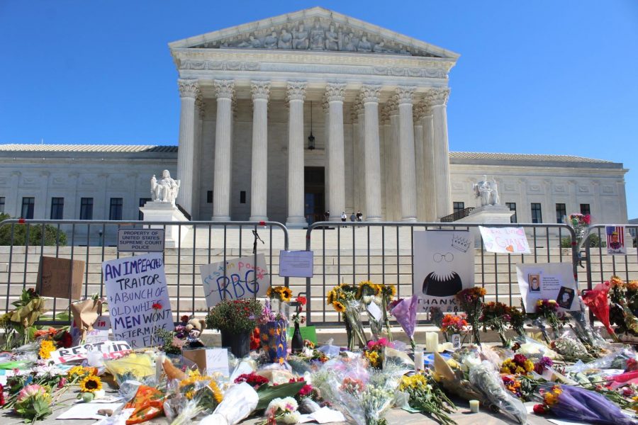 Flowers, posters, and candles fill the steps of the Unites States Supreme Court. 