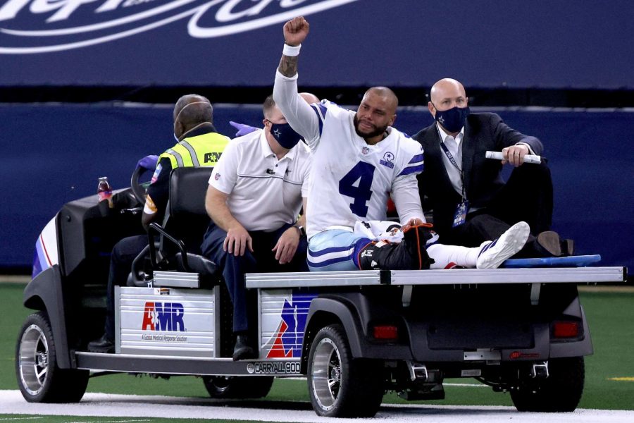 An emotional Prescott gets carted off the field after a devastating injury to the right leg.