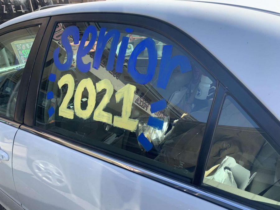 Madelyn Venable decorates her car for March to Graduation. 