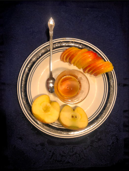 Members of the Jewish community take part in eating apples and honey during the annual celebration.