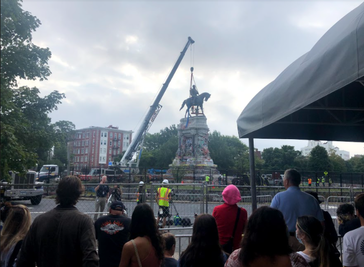 Richmond residents watch in awe as the Robert E. Lee memorial is deconstructed.