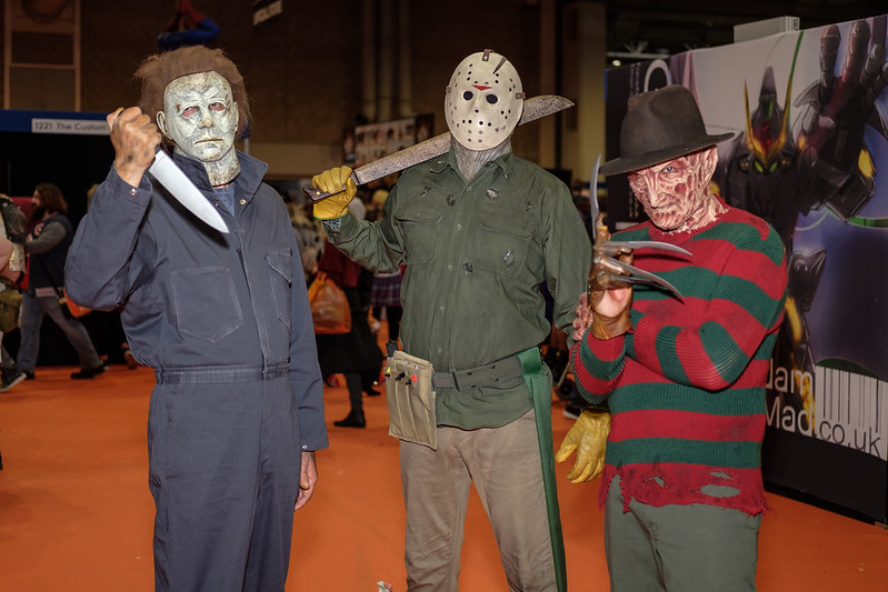 People dressed as horror icons Michael Myers, Jason Voorhees, and Freddy Krueger pose for the camera!