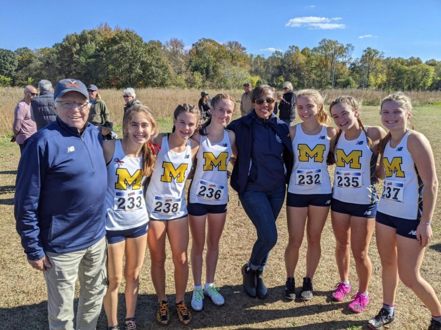 Coach+Stan+Morgan+and+Athletic+Director+Shea+Collins+pose+with+the+Varsity+Girls+after+learning+they+will+compete+at+the+state+meet+in+less+than+two+weeks.