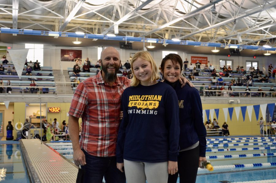 Mackenzie Yates and her parents on the senior swim night.