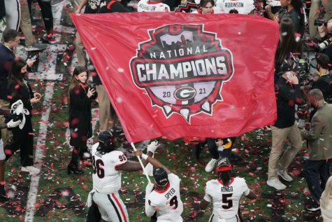 Georgia players celebrate with their championship flag