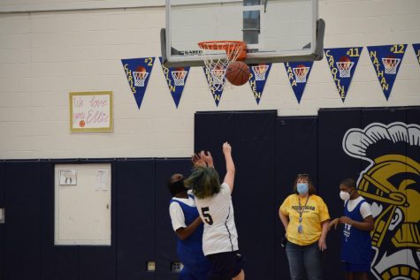 Midlo assertively attacks the basket for a potential score.