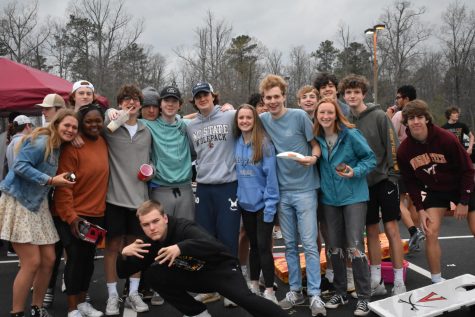 Students gather in the school parking lot at the breakfast tailgate. 