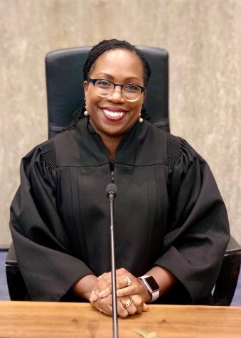 The recently confirmed Justice Ketanji Brown Jackson wears judicial robes and a glowing smile in her official portrait.