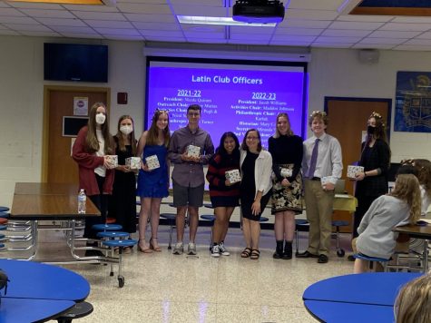 The 2021-2022 Latin Club officers smile with their gifts and Ms. Petersen.