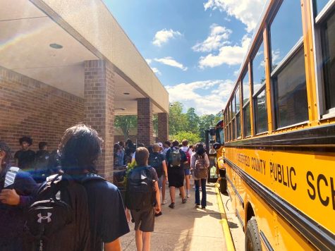 Students scatter to find their buses amidst the first day of school chaos.