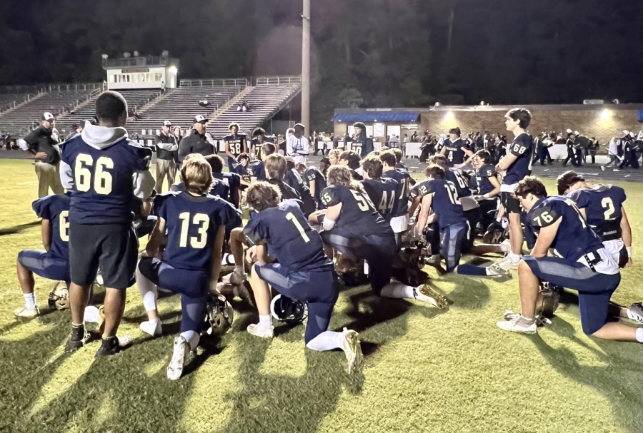 Midlos+varsity+football+team+kneels+down+to+discuss+their+remarkable+win+over+the+Monacan+Chiefs