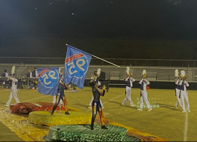 Color guard members from a traffic-themed performance toss their flags to the sky.