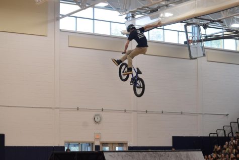 BMX performer performs for thousands of students.