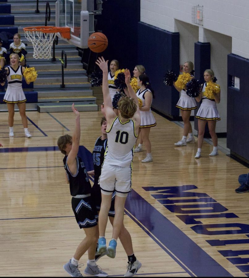 Junior Forward Harry Clarke attempts a shot over a Cosby defender