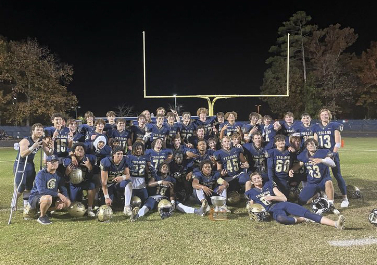 Trojan Football Celebrates after a win against the James River Rapids in the Coal Bowl