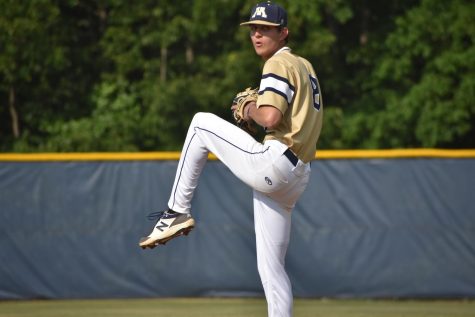 2021-2022 senior warms up with his catcher prior to their home matchup