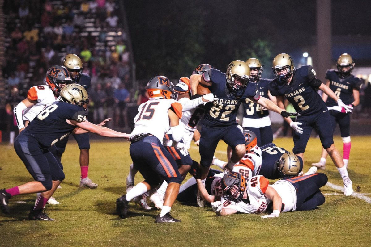 2021 Senior Running Back Max McKey attempts to gain yardage downfield against Manchester's defense.