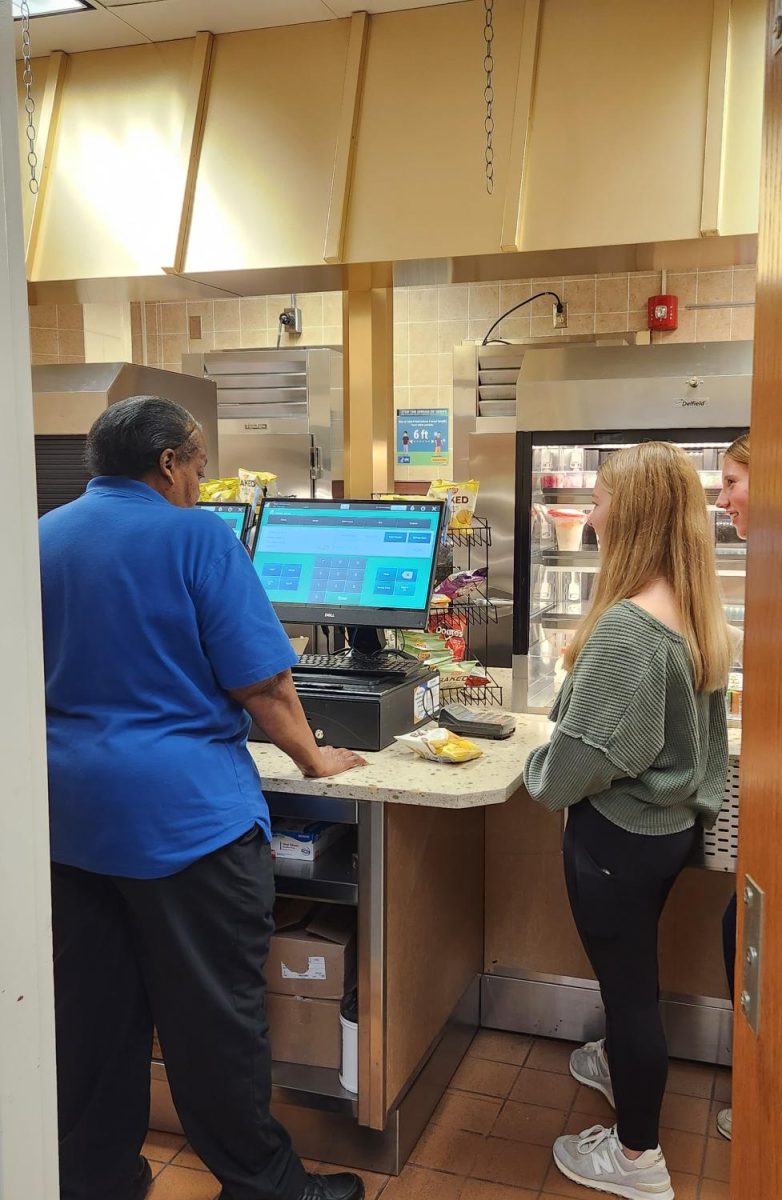 Students get in line to buy their lunch. 