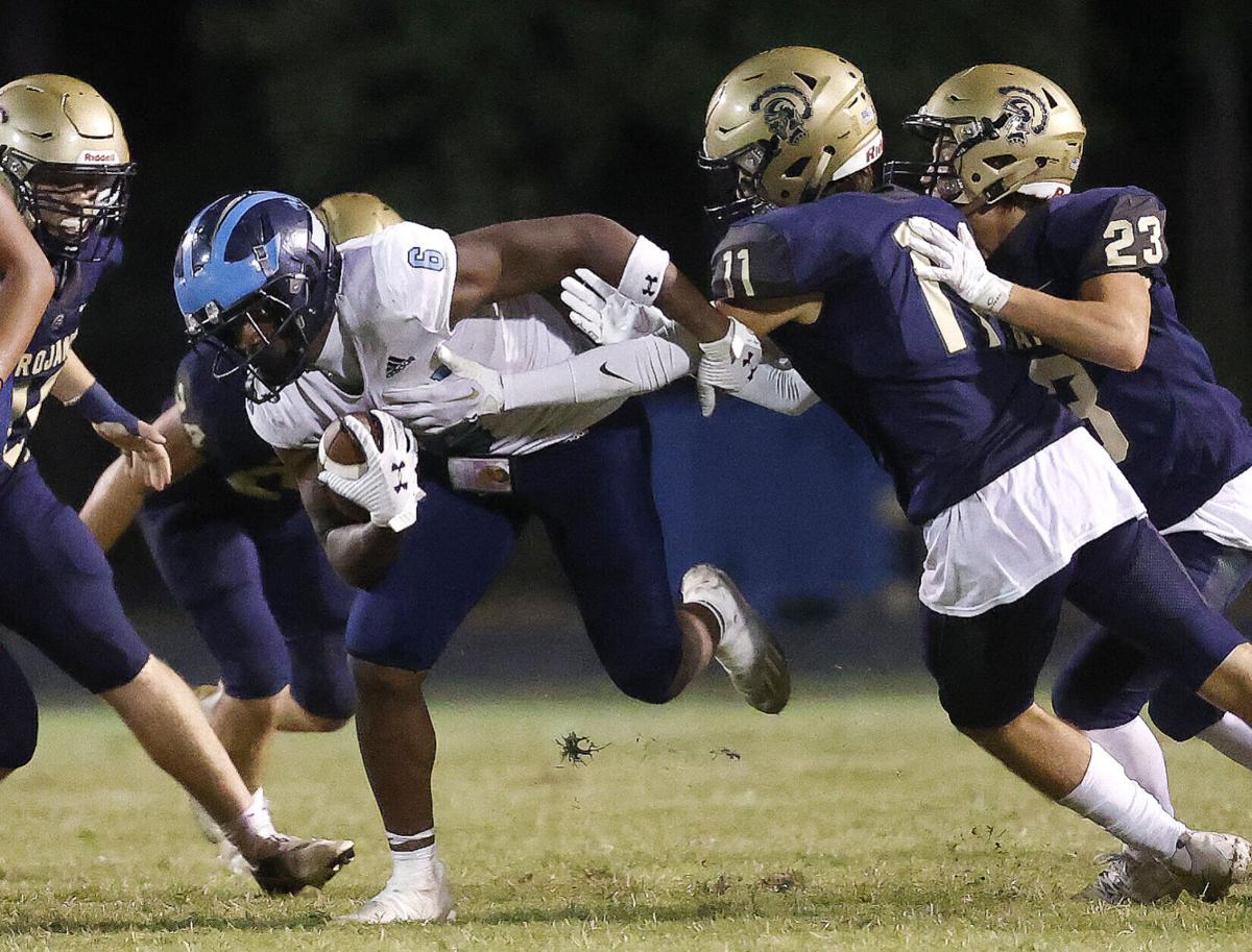 2023 senior Ethan Shelor attempts to tackle 2023 Senior Javion Williams in the Trojans 15-7 win over L.C. Bird.