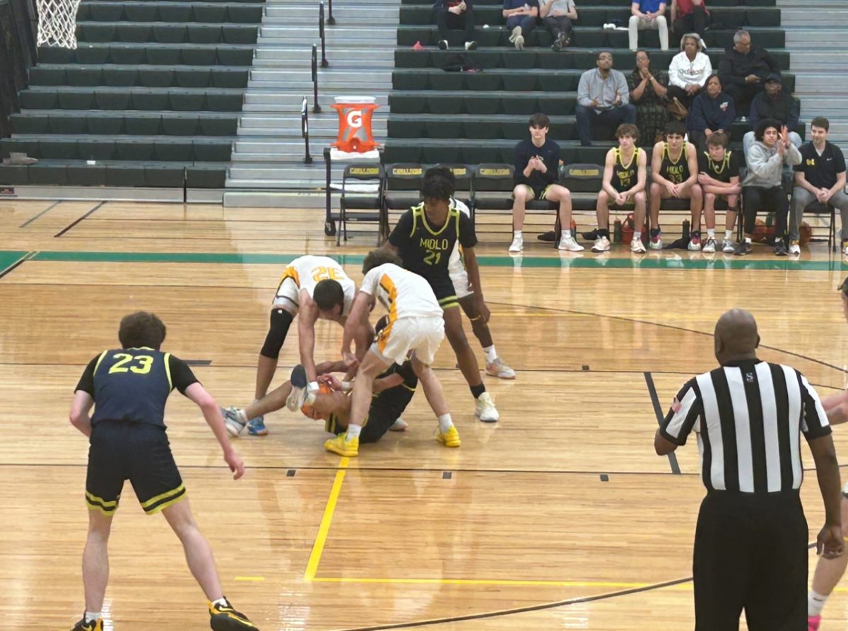 Senior Guard Chase Chambers fighting for a loose ball against two Clover Hill defenders.