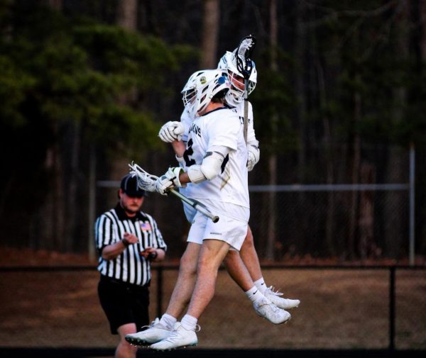 The pair of Trojan teammates celebrate during  a win against the Monacan Chiefs in March