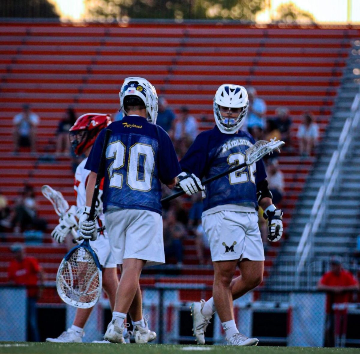 Senior Enforcer Stephen Siegel and Junior Goaltender Robert Filippone walk past each other cordially in their 16-7 road win against the Monacan Chiefs on April 29.