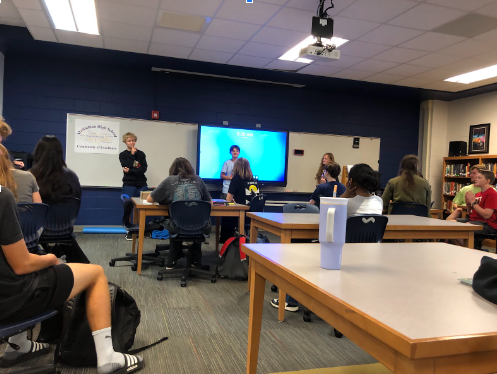 Students learn how to sign the ABCs in the ASL club.