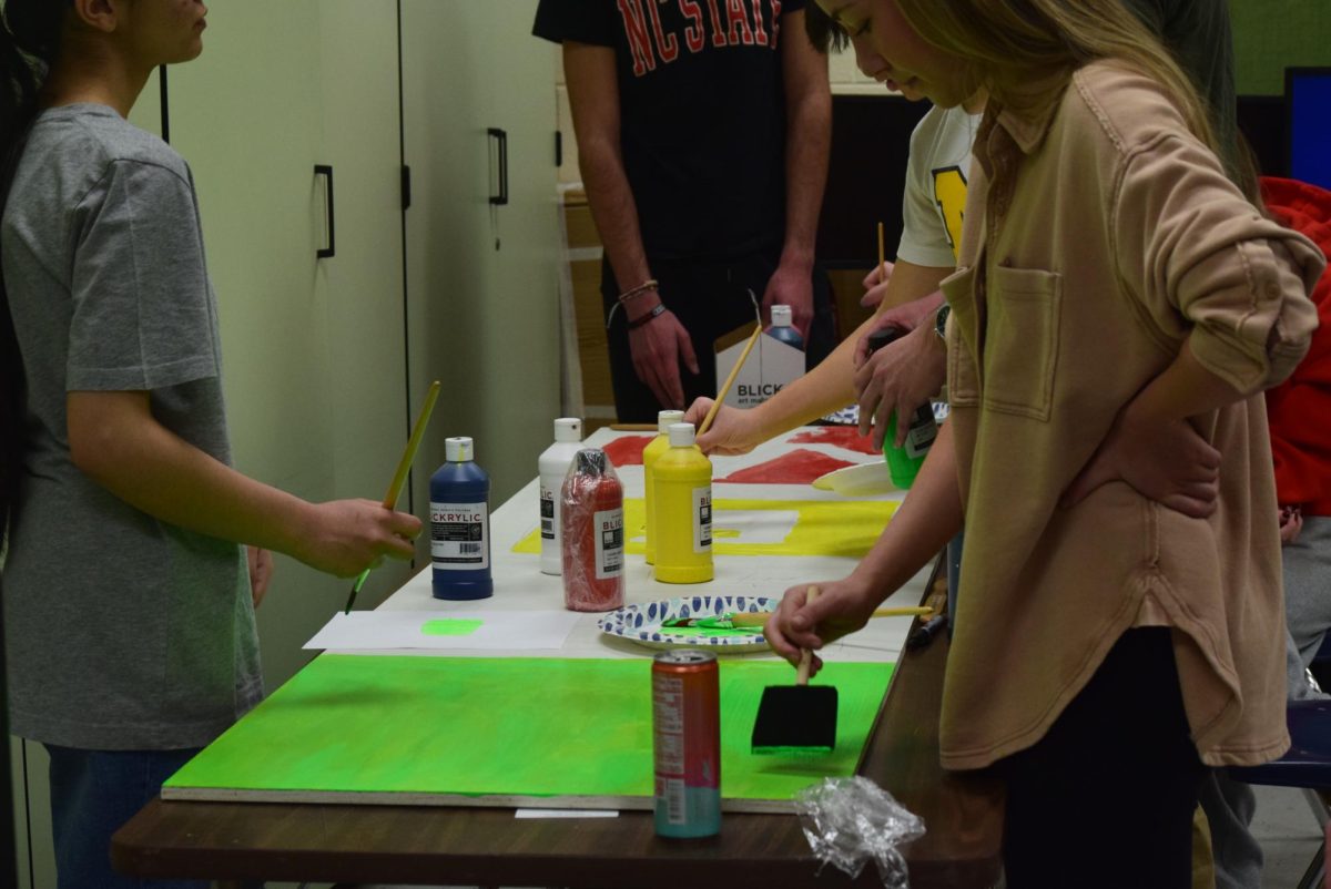 Students in S.T.E.M club paint their board.