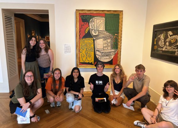 Students posing in front of one of Picasso's paintings at the field trip.