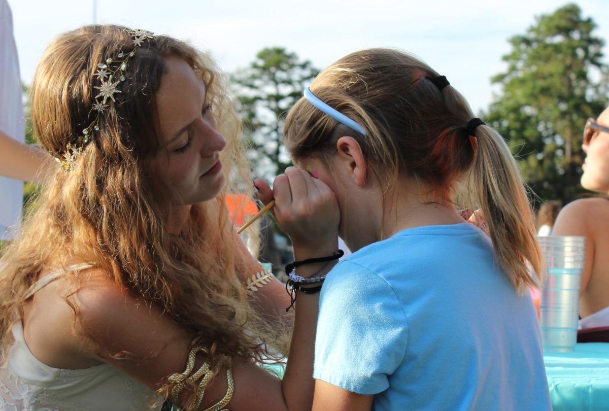 Lily Oberg face painting at the Homecoming Carnival